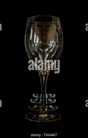 Four Wine glasses in a straight row with black background Stock Photo