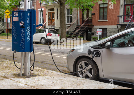 Montreal, CA - 25 May 2019: Chevrolet Volt electric car plugged into an EV charging station. Stock Photo