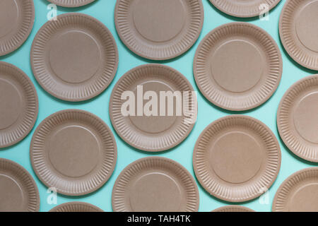Paper disposable plate pattern on pastel blue background. Summer party, kitchen cutlery Stock Photo
