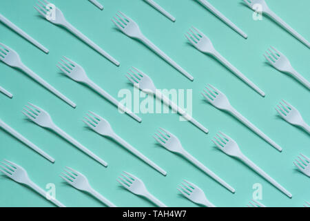 Plastic white forks on pastel blue background Stock Photo