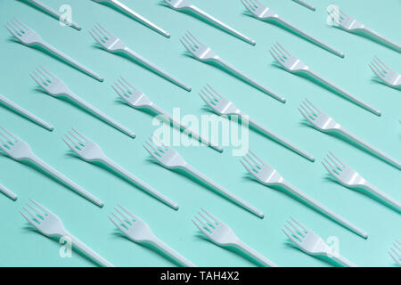 Plastic white forks on pastel blue background Stock Photo