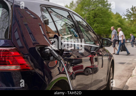 Montreal, CA - 25 May 2019: Electric car plugged into an EV charging station. Stock Photo