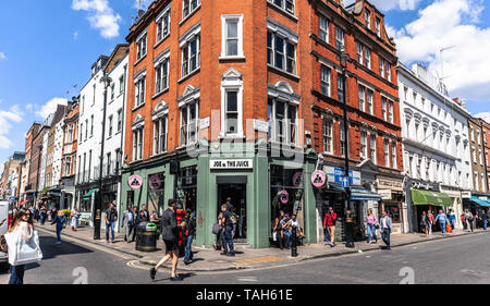 Soho London street corner scene with Costa coffee shop and people ...