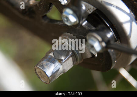 metal nut on the rear wheel of the bike Stock Photo