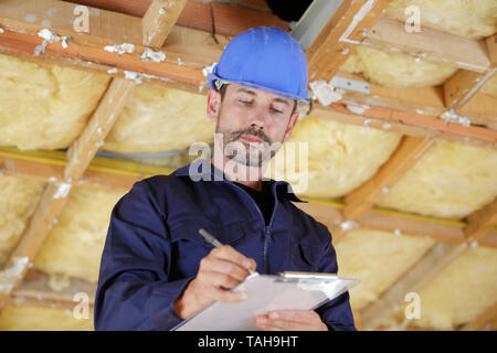 foreman making notes in renovation property Stock Photo