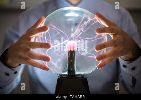 Close-up Of Fortune Teller Holding Hand Over The Glowing Crystal Ball Stock Photo