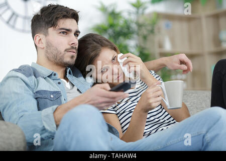 couple watching movie woman wiping away tears Stock Photo