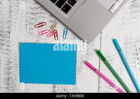 Trendy metallic laptop blank sticky note colored clips pens lying vintage Stock Photo