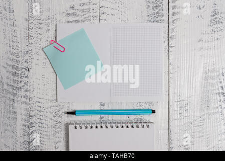 Open squared spiral notepad clip note highlighter lying old wooden background Stock Photo