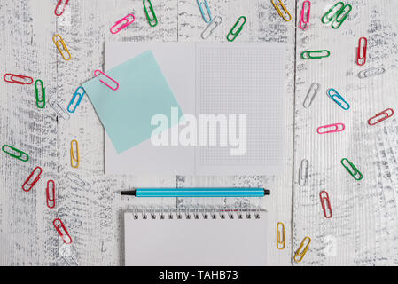 Squared spiral notepad clips note highlighter lying old wooden background Stock Photo
