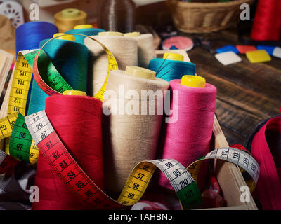 Coil threads for overlock and measuring band in sewing supplies Stock Photo