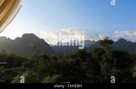 View from a restaurant on the karst hills landscape along Nam Song (Xong) river, Vang Vieng, Laos Stock Photo