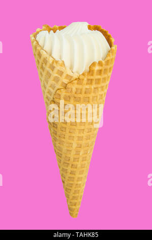 Vanilla ice cream in waffle cone isolated on bright pink and Lee crimson background, vertical close-up frame. Stock Photo