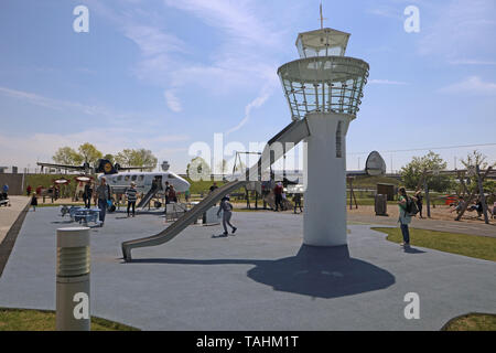 MUNICH, GERMANY - MAY 19, 2019 View of the Munich Airport visitor park: the playground with the big toy plane and a mini control tower with the runway Stock Photo