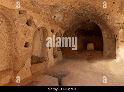 Old frescoes on the ruins of the stone walls of the prayer hall carved into the old sandstone rock in the valley of Cappadocia Stock Photo