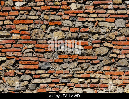 Composite old stone and bricks wall with rough surface as background Stock Photo