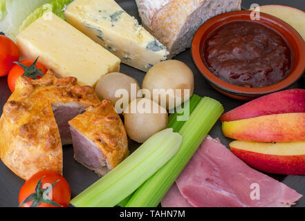 Ploughman's Lunch, a cold meal of bread, cheese, meat and onions. Stock Photo