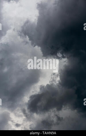 gray incoming storm clouds dark closeup backdrop, captured on 100 mm telephoto lens Stock Photo