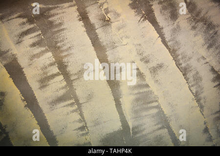 Begin painting wall yellow color on cement background Stock Photo