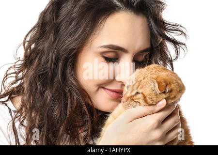 Young woman with her cute funny cat on white background Stock Photo