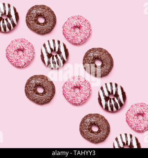Colorful donuts pattern on pink background Stock Photo