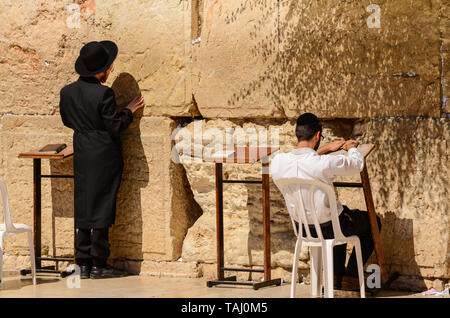 Jerusalem/Israel- July 11, 2014: Two Orthodox Jewish men praying at the Western Wall in Jerusalem, Israel Stock Photo