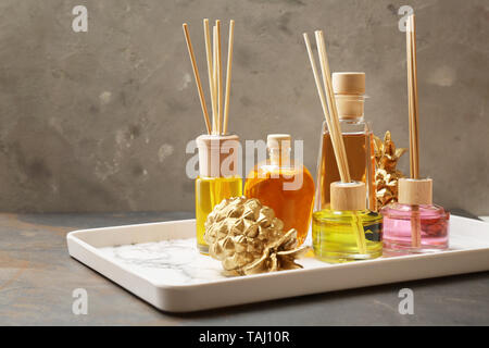 Tray with different reed diffusers on table Stock Photo