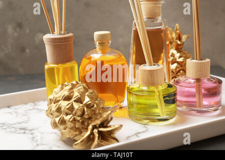 Tray with different reed diffusers on table Stock Photo