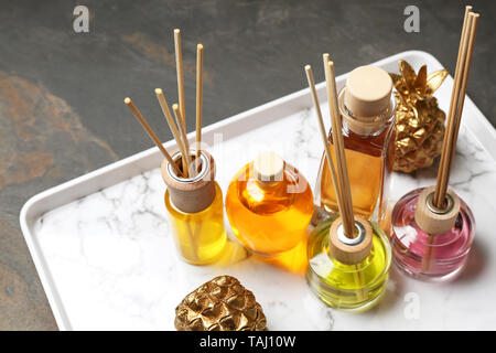 Tray with different reed diffusers on table Stock Photo