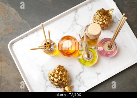 Tray with different reed diffusers on table Stock Photo
