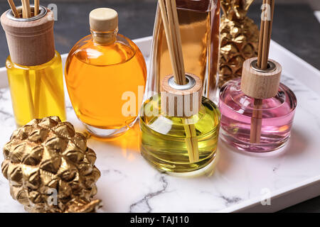 Tray with different reed diffusers on table Stock Photo