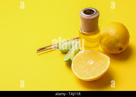 Citrus reed diffuser on color background Stock Photo