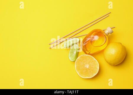 Citrus reed diffuser on color background Stock Photo