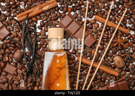 Reed diffuser, chocolate and cinnamon on coffee beans Stock Photo