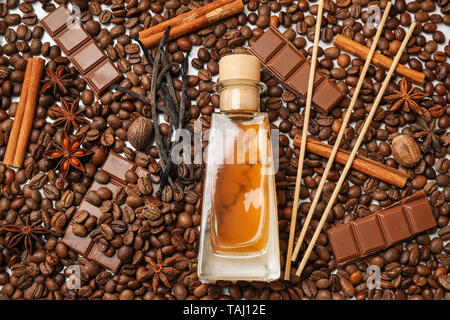 Reed diffuser, chocolate and cinnamon on coffee beans Stock Photo