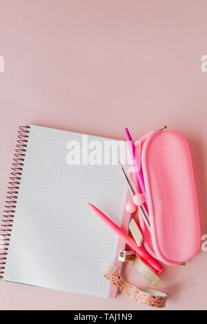 Back to school. Notebook, pencil case with pen and pencils on pink background. Stock Photo