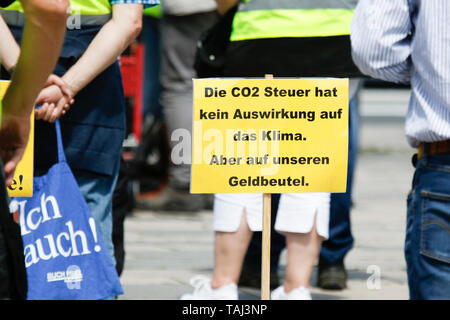 Wiesbaden, Germany. 25th May, 2019. A sign reading 'The CO2 tax has no effect on the climate, but on our purse' stands on the ground. Under 100 right wing protesters marched with yellow vests through Wiesbaden, to protest against the German government. They were confronted by small but loud counter protest. Credit: Michael Debets/Pacific Press/Alamy Live News Stock Photo