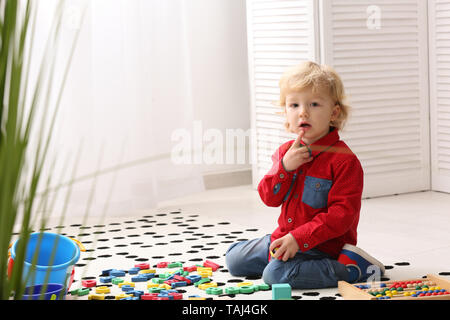 Cute little boy playing at home Stock Photo