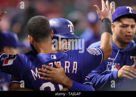 Texas Rangers' Ronald Guzman, right, scores on a single by Rougned Odor ...