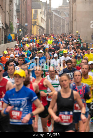 Edinburgh, Scotland, UK. 26th May, 2019. Many runners taking part in the Edinburgh Marathon Festival Marathon run down the Royal Mile in Edinburgh's Old Town towards Holyrood. Credit: Iain Masterton/Alamy Live News Stock Photo