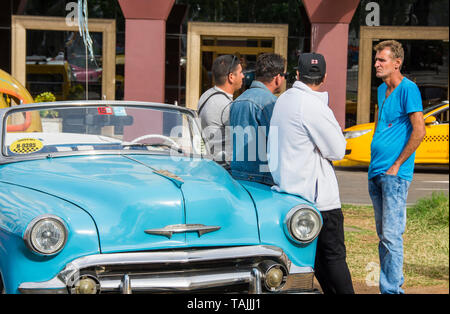 Havana, Cuba - Taxis wait for fares in front of Hotel Parque Central. Classic American cars from the 1950s, imported before the U.S. embargo, are comm Stock Photo