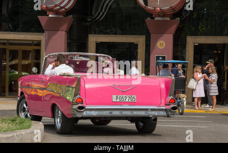 Havana, Cuba - Taxis wait for fares in front of Hotel Parque Central. Classic American cars from the 1950s, imported before the U.S. embargo, are comm Stock Photo