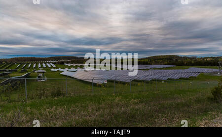 Solar farm featuring array of several solar panels Stock Photo
