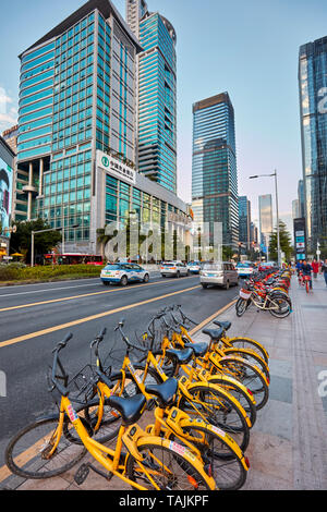 City bicycles for rent parked on street in Futian Central Business District. Shenzhen, Guangdong Province, China. Stock Photo