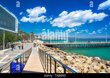 Beautiful sea promenade with palms, sculptures and pools in Limassol, Cyprus Stock Photo