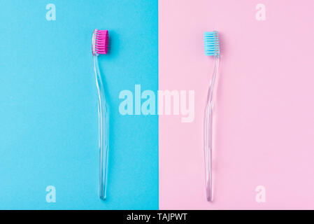 Two plastic toothbrushes on pastel blue and pink  background, flat lay style Stock Photo