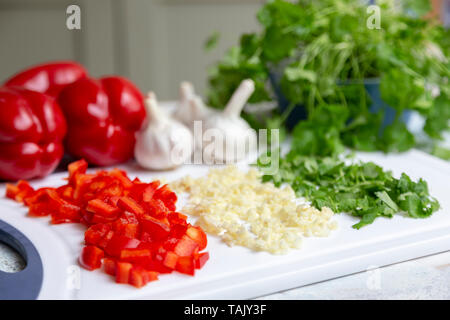 Chopped vegetables, garlic, sweet red peppers and coriander Stock Photo