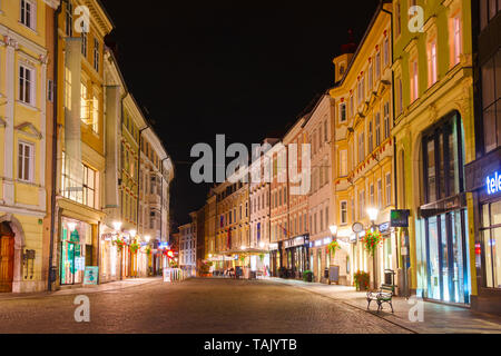 Town Square (Mestni trg) at night with illuminated facedes of shops, bars, houses and restaurants. Ljubljana, Slovenia. Stock Photo