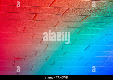 Abstract colorful light from led light on brick wall background Stock Photo