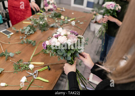 Master class on making bouquets. Summer bouquet. Learning flower arranging, making beautiful bouquets with your own hands. Flowers delivery Stock Photo